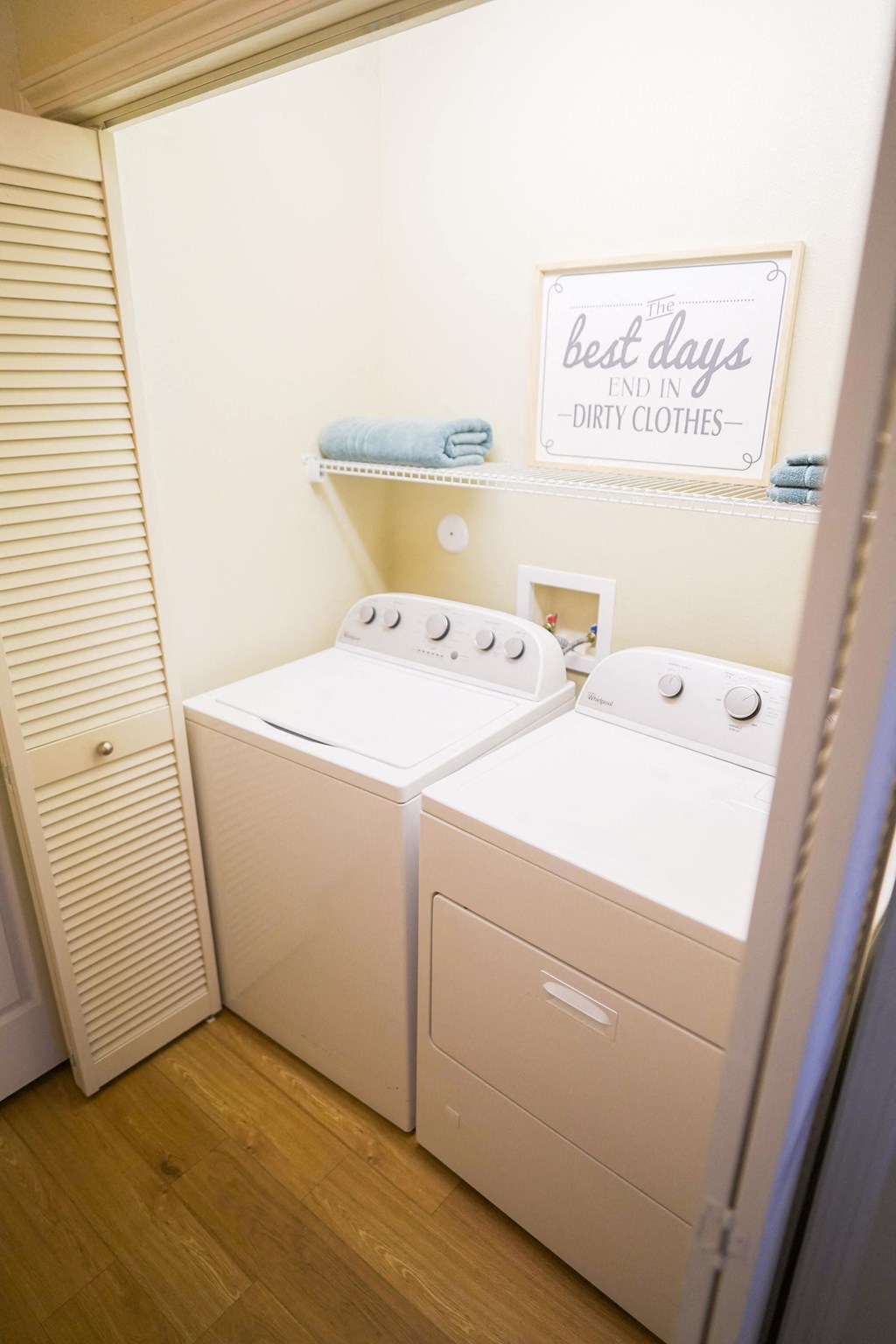 a small laundry room with two washes and a dryer