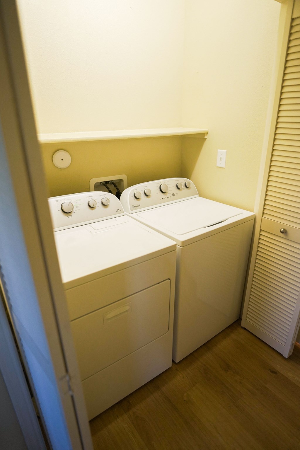 a laundry room with two washes and a dryer