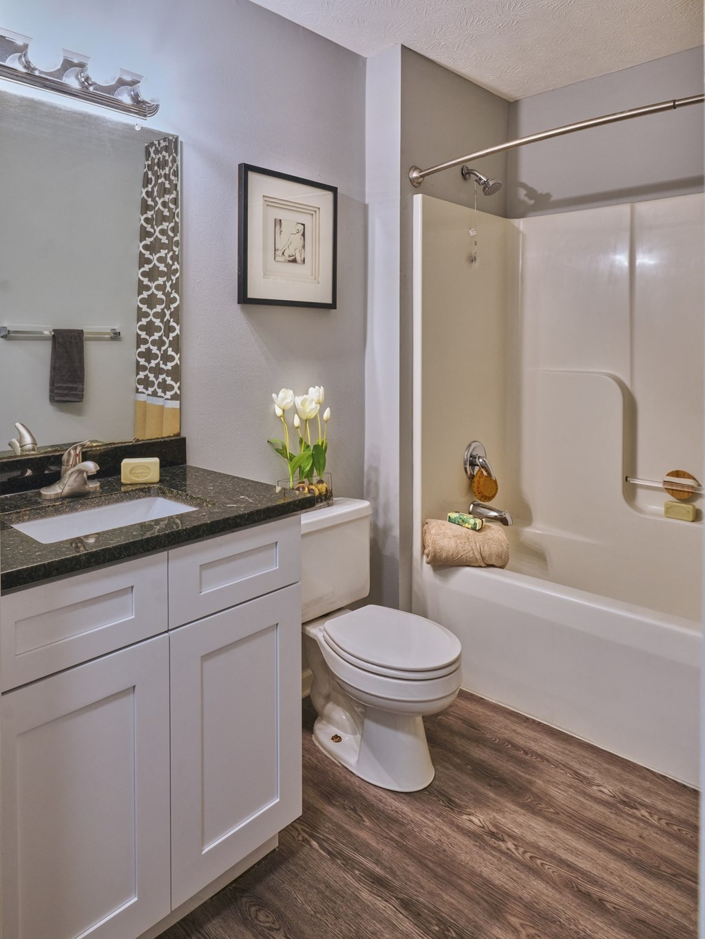 a bathroom with a toilet and a shower and a sink