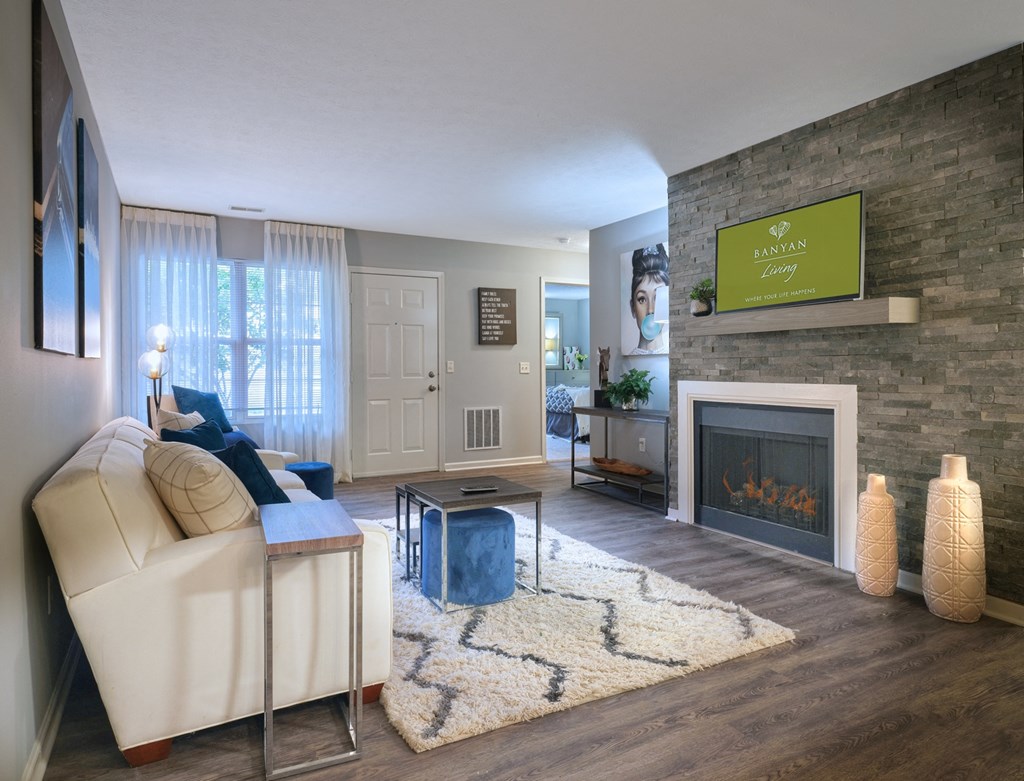 a living room with a white couch and a fireplace