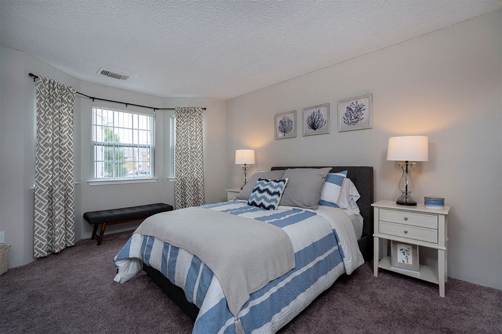 a bedroom with a bed and a window