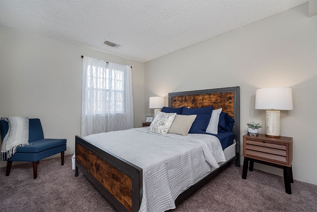 a bedroom with a bed and a chair