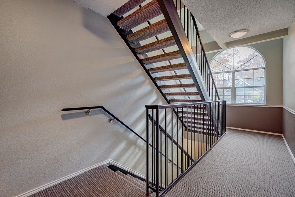 a spiral staircase in a home with a window