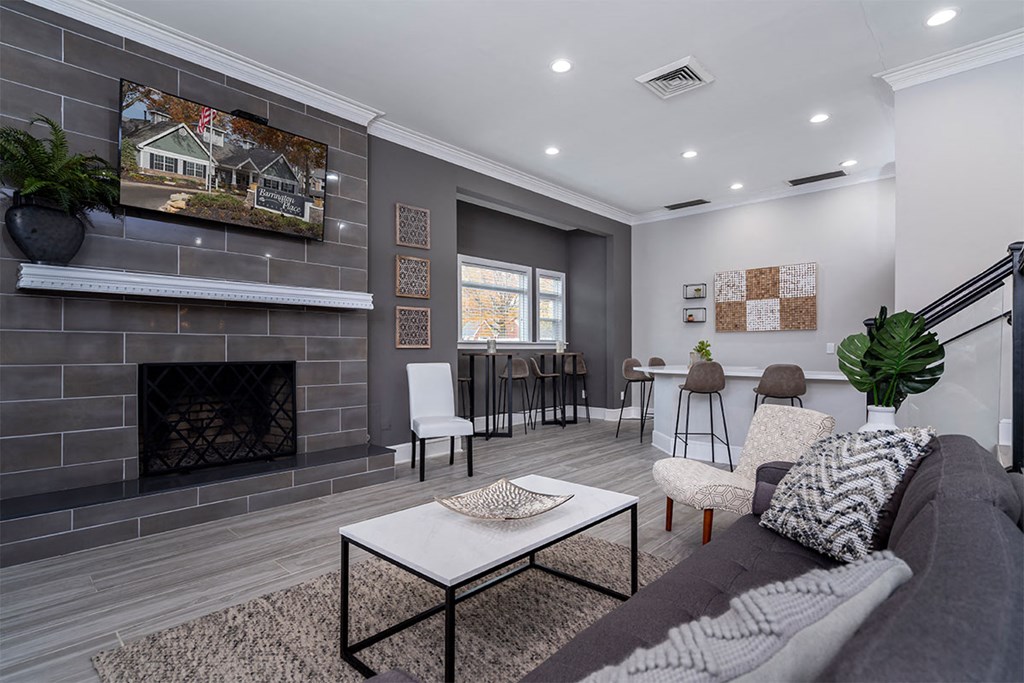 a living room with a fireplace and a table with chairs