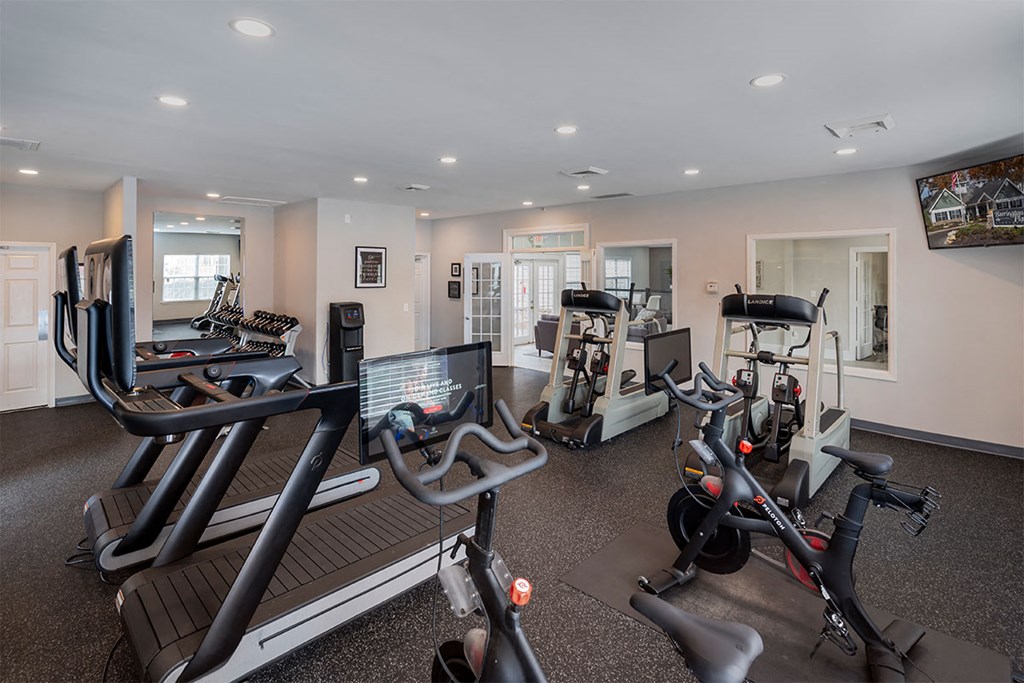 a gym with treadmills and other exercise equipment
