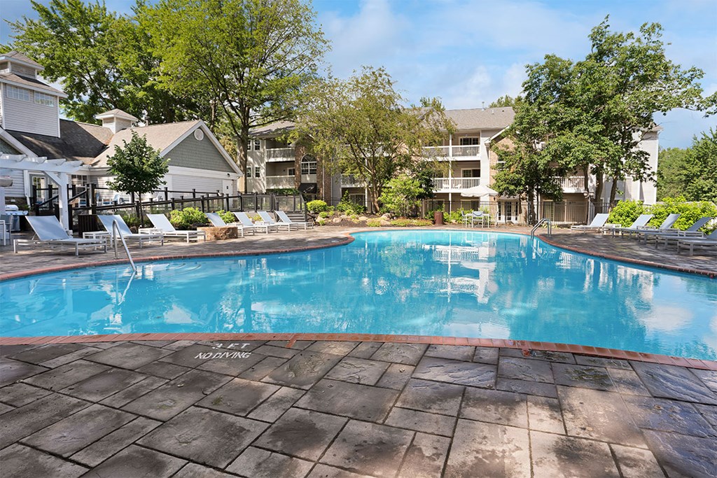 a resort style swimming pool with chairs around it