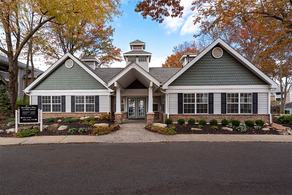 the front of a house with a sign in front of it