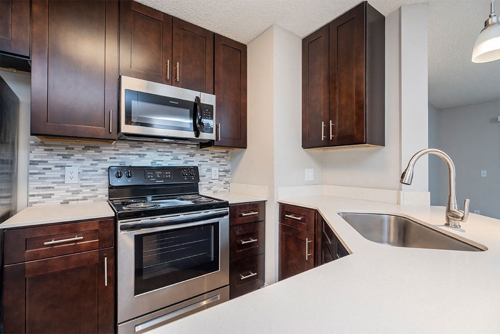 a kitchen with stainless steel appliances and wooden cabinets