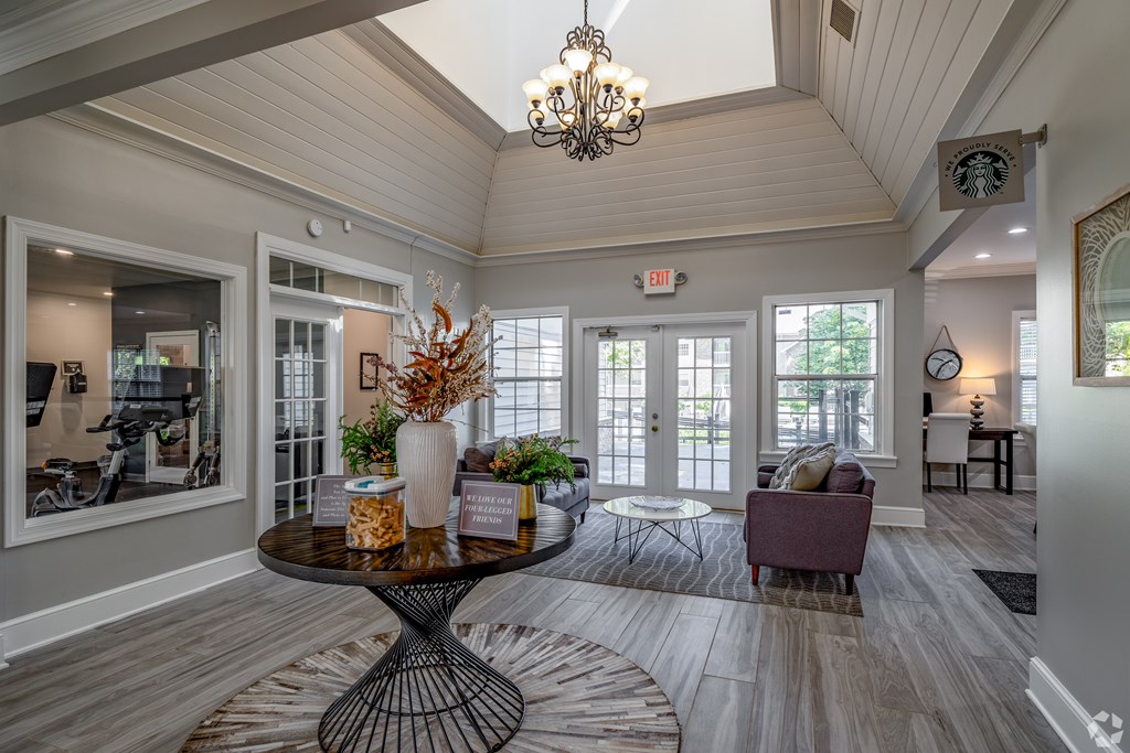the view of a living room with a table and chairs