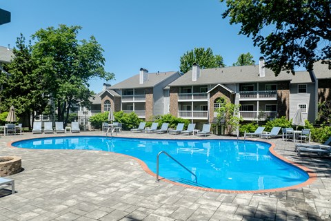 a large swimming pool in front of an apartment building