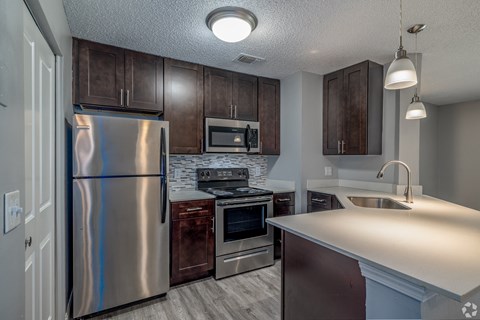 a kitchen with stainless steel appliances and wooden cabinets