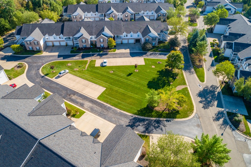 an aerial view of a neighborhood with houses and a green lawn