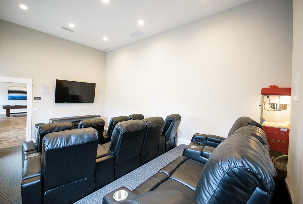 a living room with leather couches and a tv