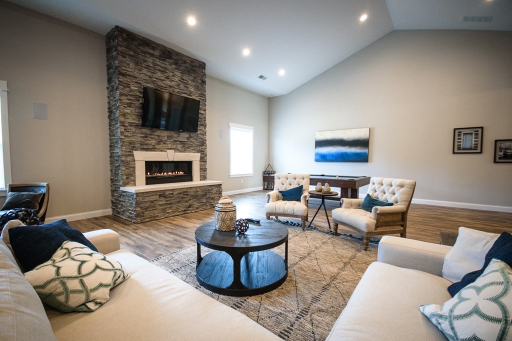 a living room with couches and chairs and a fireplace