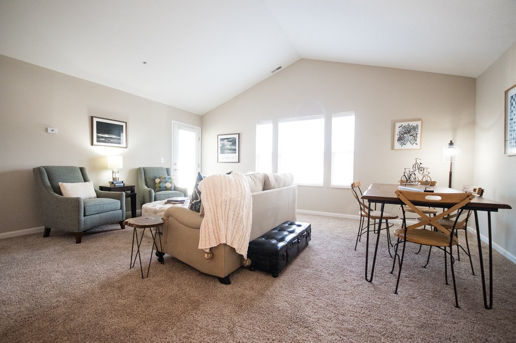 a living room and dining room with a couch and a table