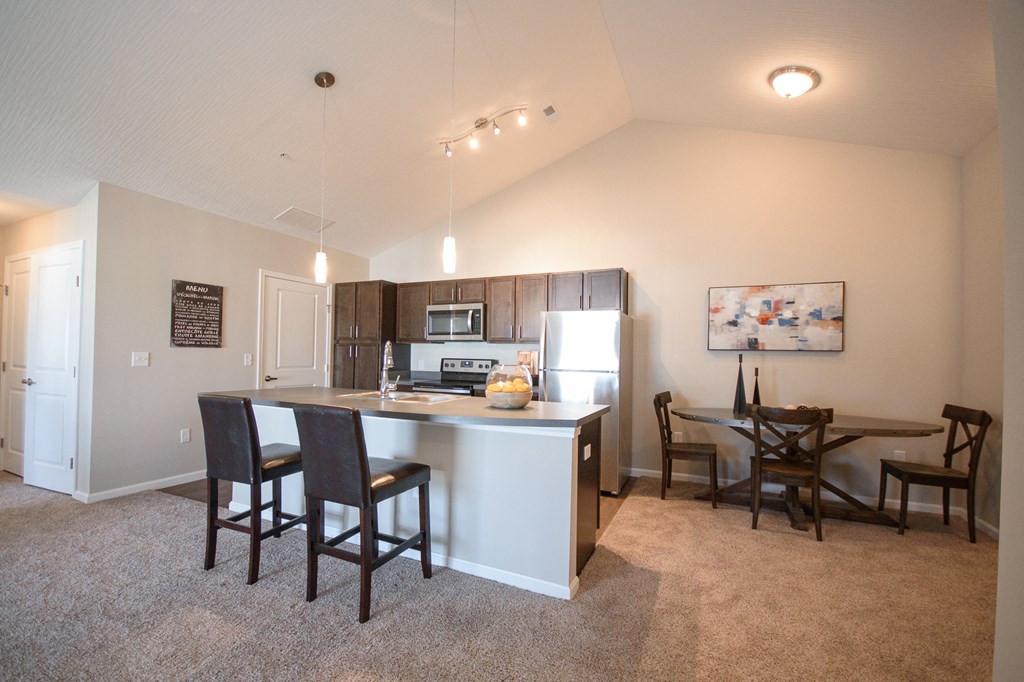 an open kitchen and dining area with a table and chairs