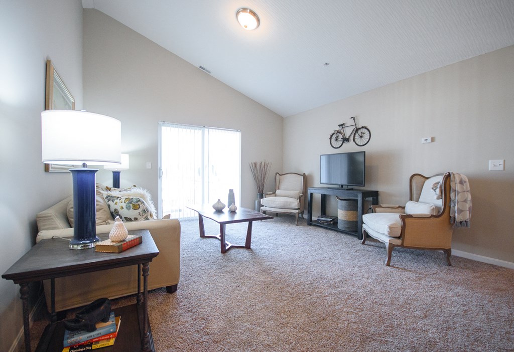 a living room with a couch and chairs and a television
