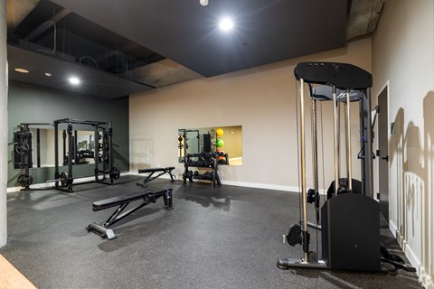 A gym with a variety of equipment including a leg press machine.