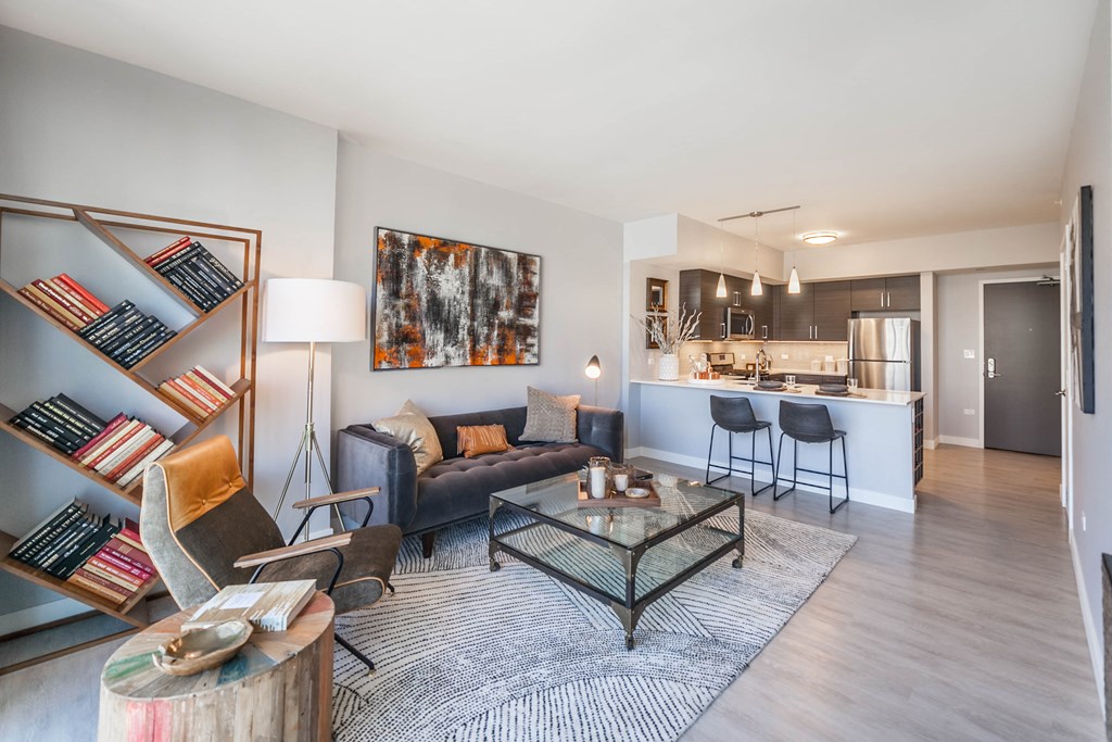 One bedroom living room with couch, tv stand, and bar stools