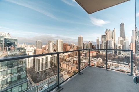 A balcony overlooks a cityscape with tall buildings.