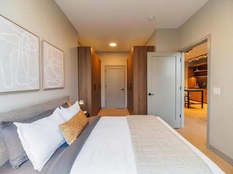 a bedroom with a large bed and a door to a bathroom