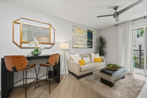A modern living room with a dining table and chairs.