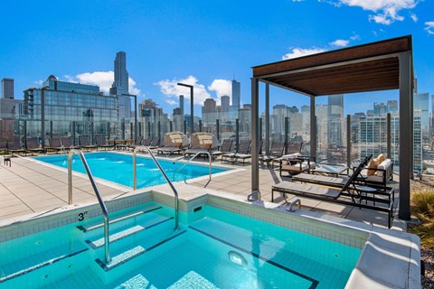 the pool on the roof of a skyscraper with the city skyline in the background