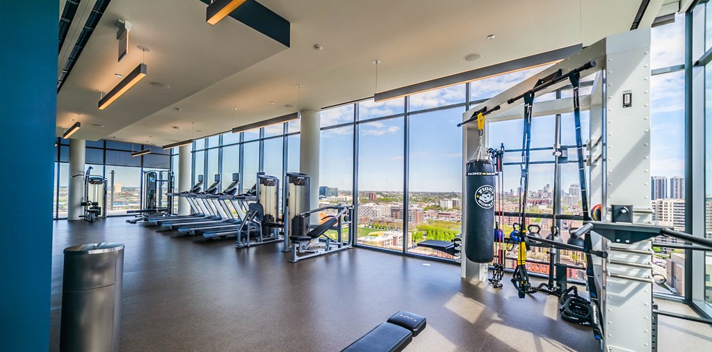 Treadmills, lifting equippment and views of chicago skyline in the fitness center