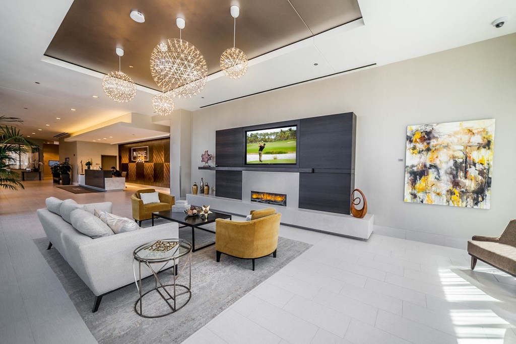 Lobby waiting area with couch, chairs, and fireplace
