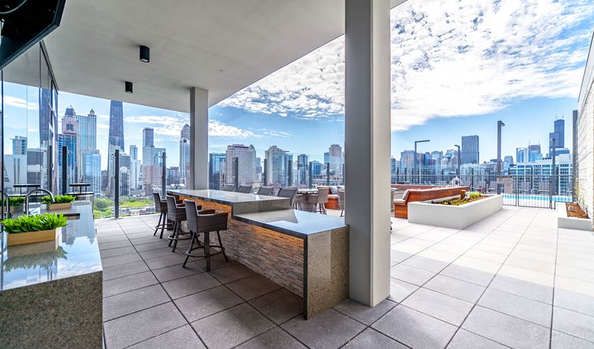 a view of a city skyline from a terrace with a bar