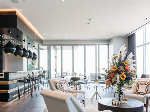 a living room filled with furniture and a table with flowers