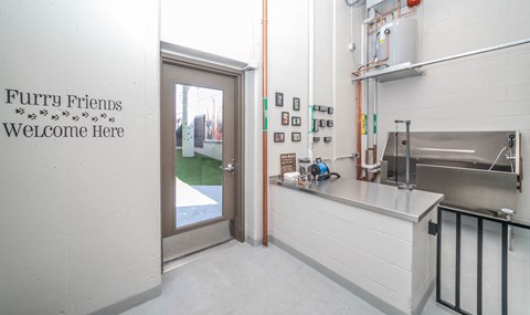 a kitchen with a counter and a door to a classroom