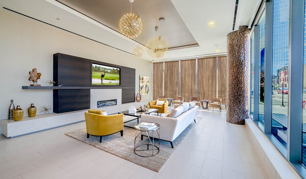Lobby waiting area with couch, chairs, and fireplace