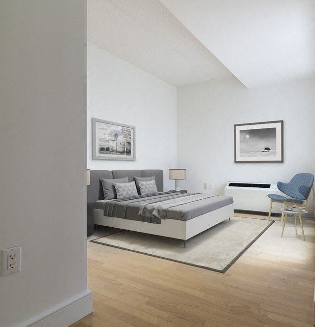 a bedroom with a bed and a chair