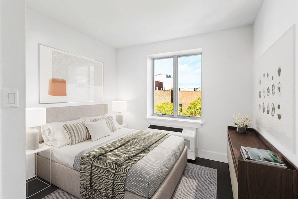 a bedroom with a bed and a large window