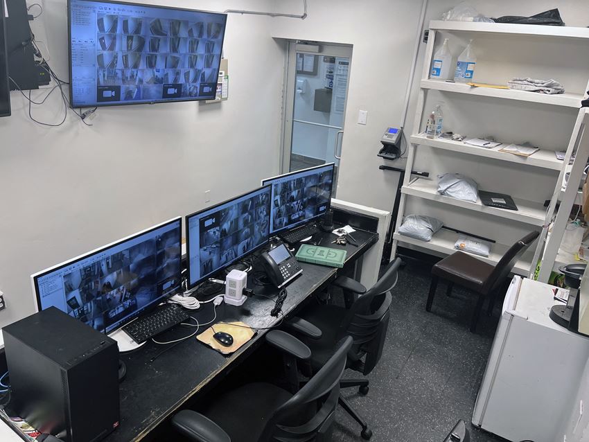 an office with four computer monitors on a desk an office with four computer monitors on a desk