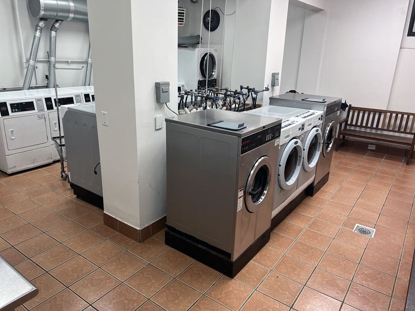 a row of washing machines and other appliances in a laundry room a row of washing machines and other appliances in a laundry room