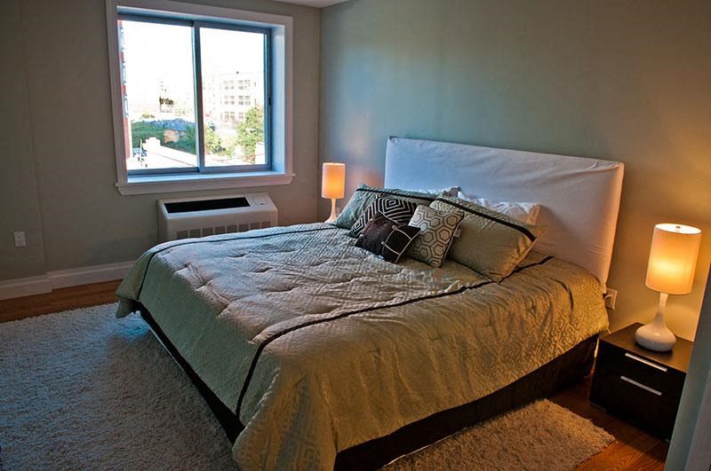 a bedroom with a large bed and a window