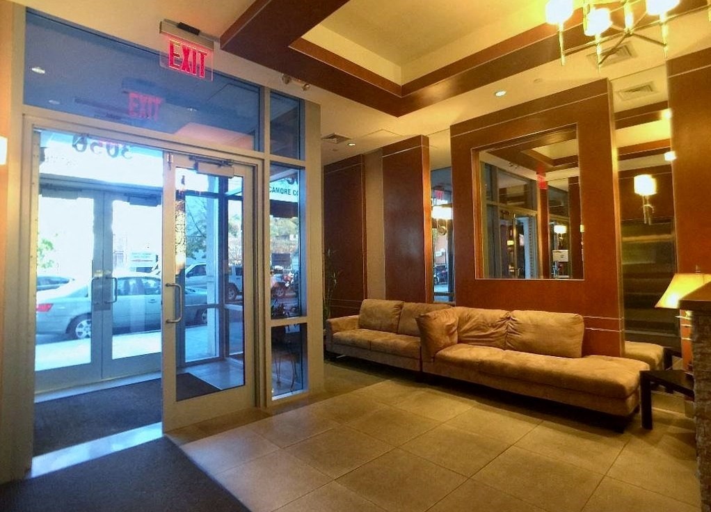 a lobby with a couch in front of a glass door