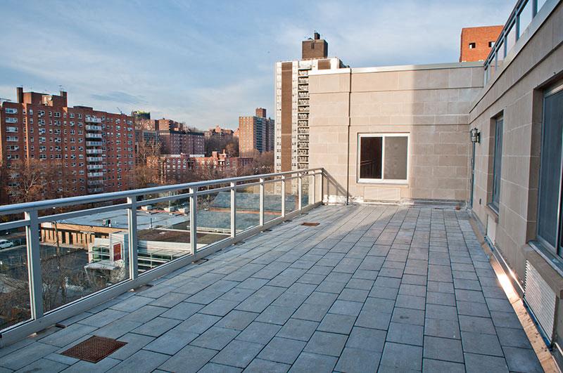 a balcony with a view of a city and a river