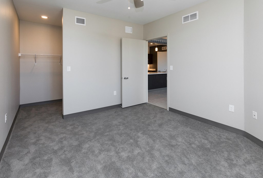 an empty living room with white walls and a white door