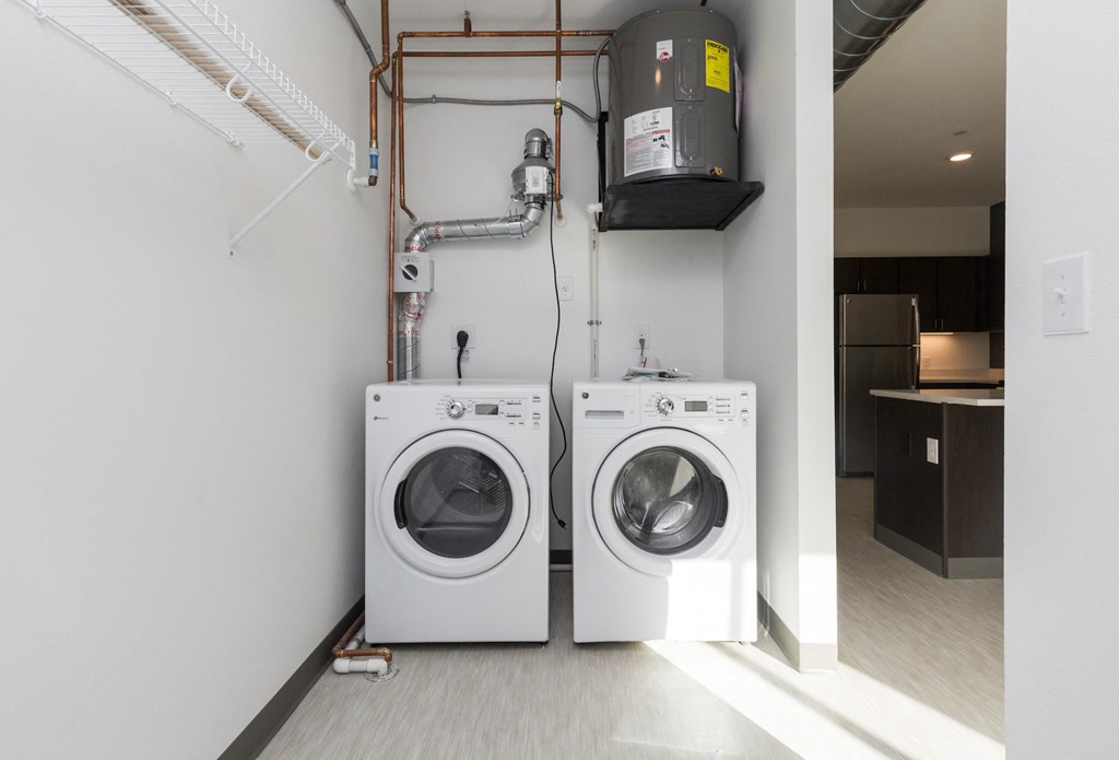 a washing machine and a dryer in a white room