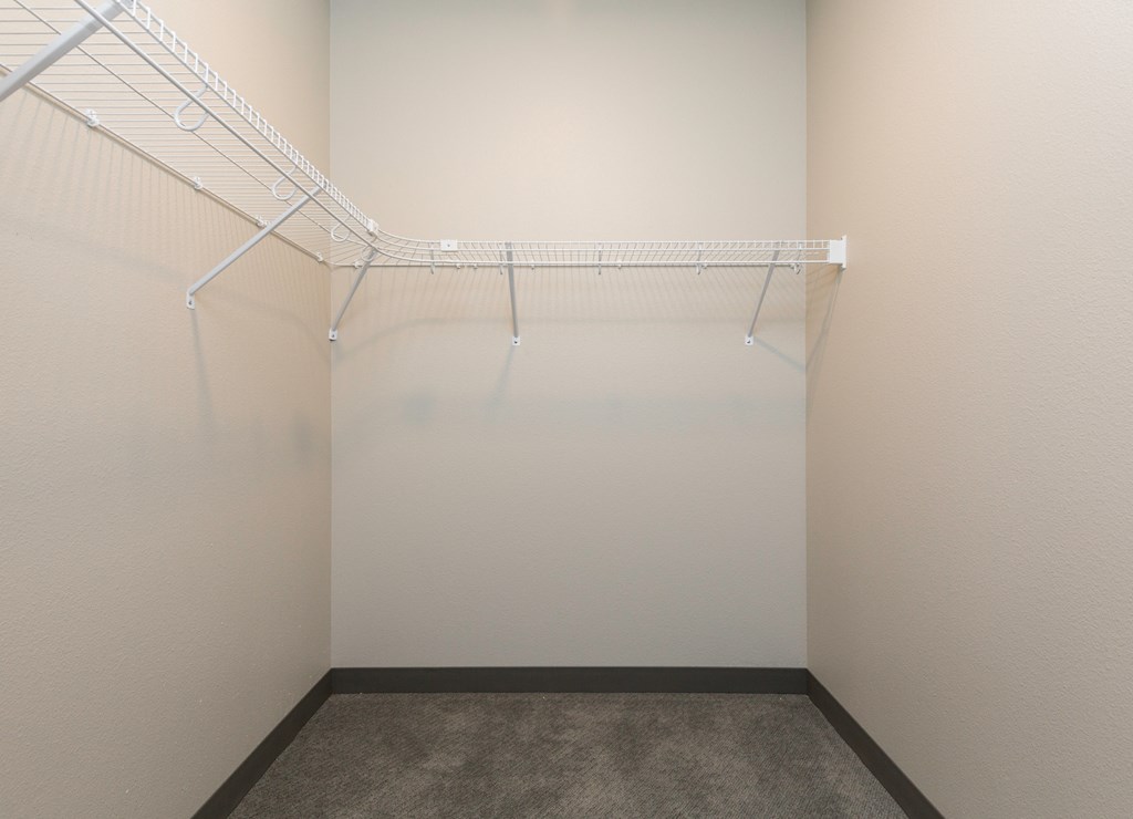 an empty closet with a wire rack on the wall
