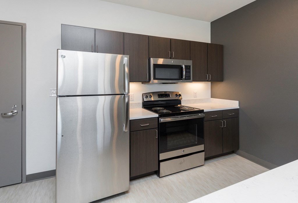 a kitchen with stainless steel appliances and a stainless steel refrigerator