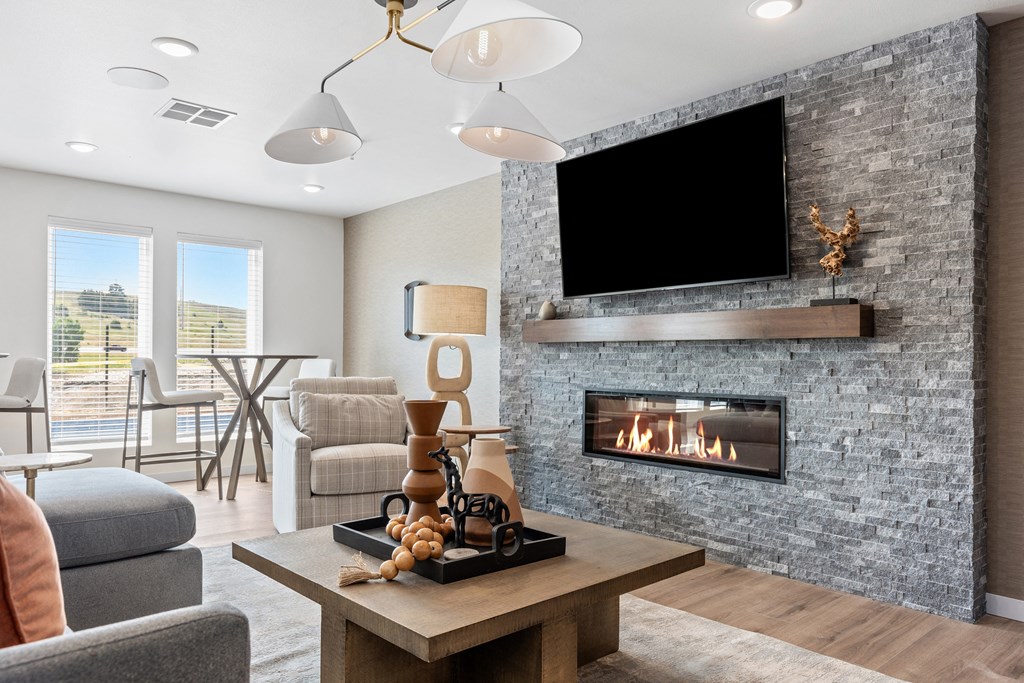 a living room with a fireplace and a television