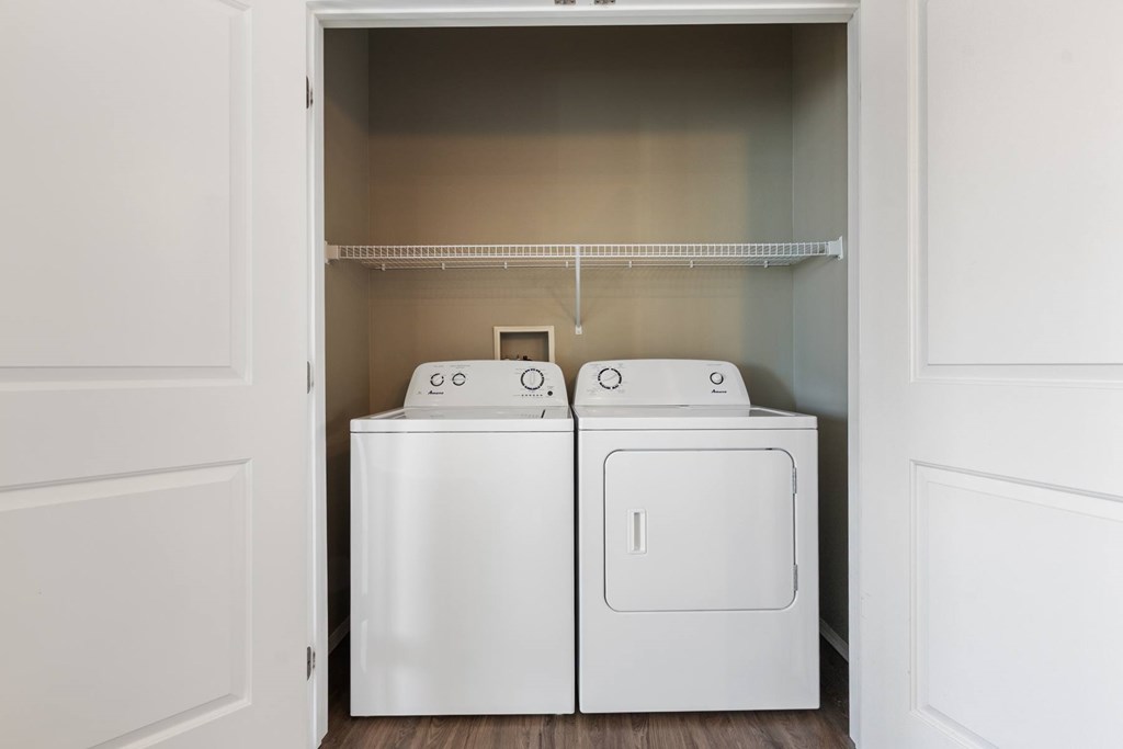 A white laundry room with a washer and dryer.