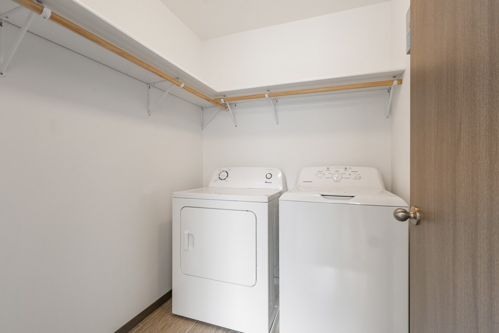 A small laundry room with a washer and dryer.