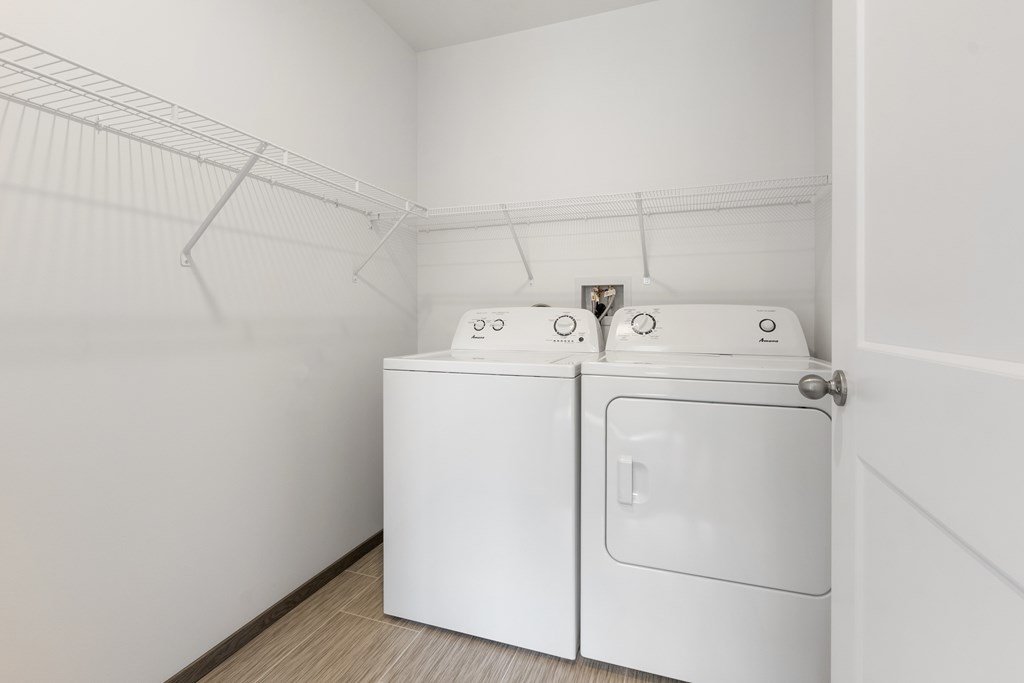 A white washing machine and dryer in a small laundry room.