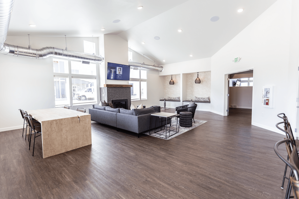 A living room with a grey couch and a wooden table.