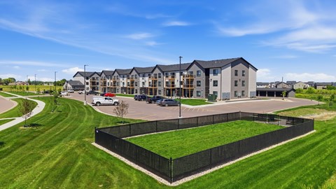 A large building with a black fence in front of it.